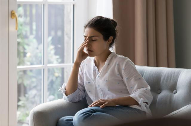 Woman worried with hand on head