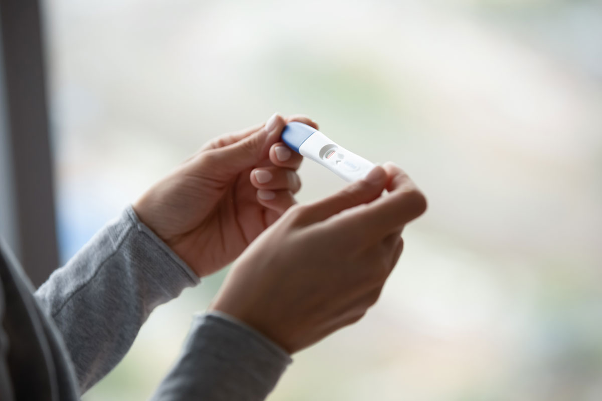 Woman holding pregnancy test